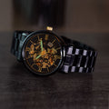 Franklord Mechanis Eclipse Noir Automatic Watch glowing luminous hands and markers in a dark setting for improved night visibility.