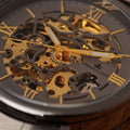 Close-up of Franklord Titanium Shadow Watch skeleton dial with gold accents, exposing the intricate mechanical movement in motion.
